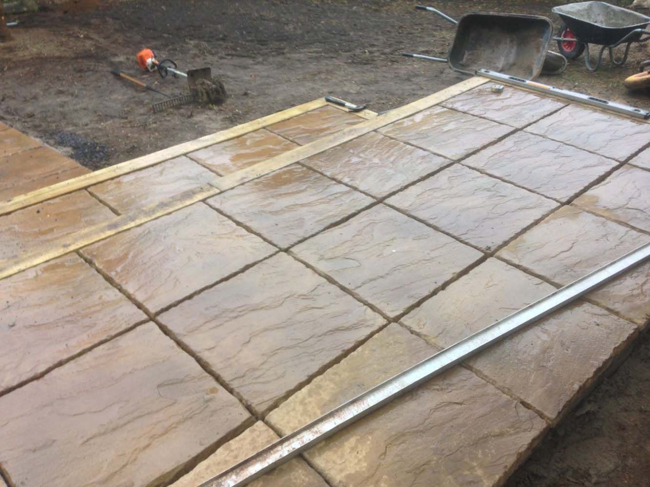 Concrete slab forms on a construction site with wooden and metal framing.