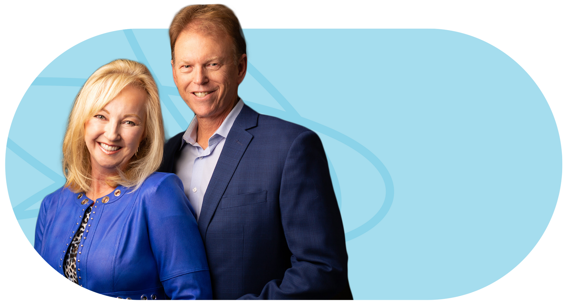 Smiling couple, woman in blue jacket, man in blue blazer.