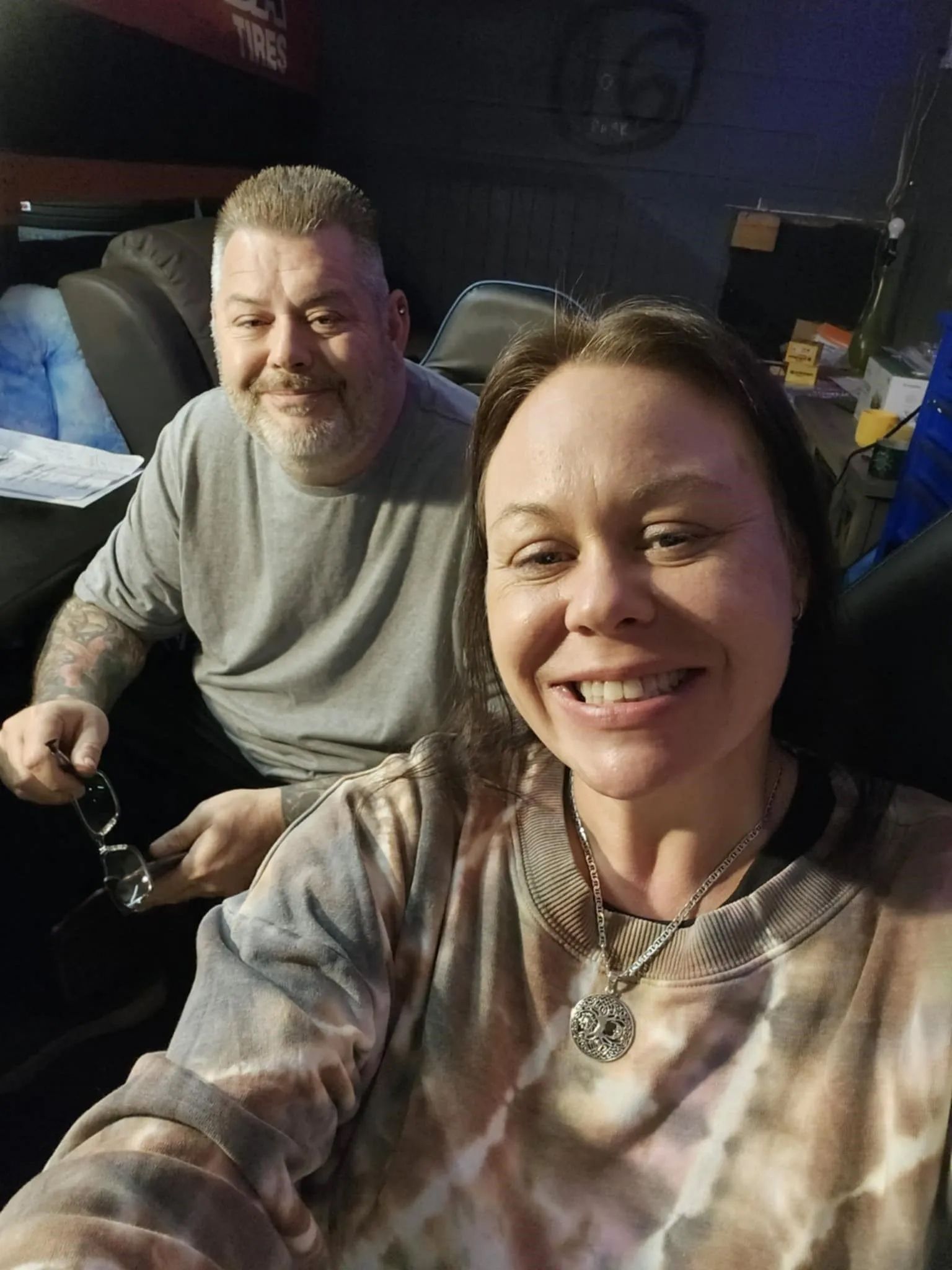 A man and a woman are sitting next to each other in a chair.