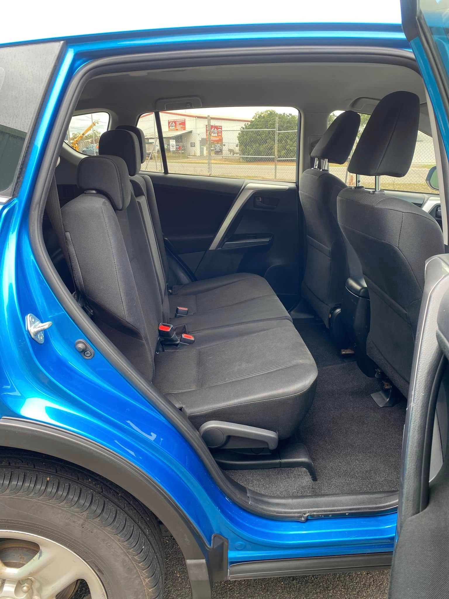 Open car door showing black rear seats and interior of a blue vehicle — Beclean Auto Detailing in Mareeba, QLD