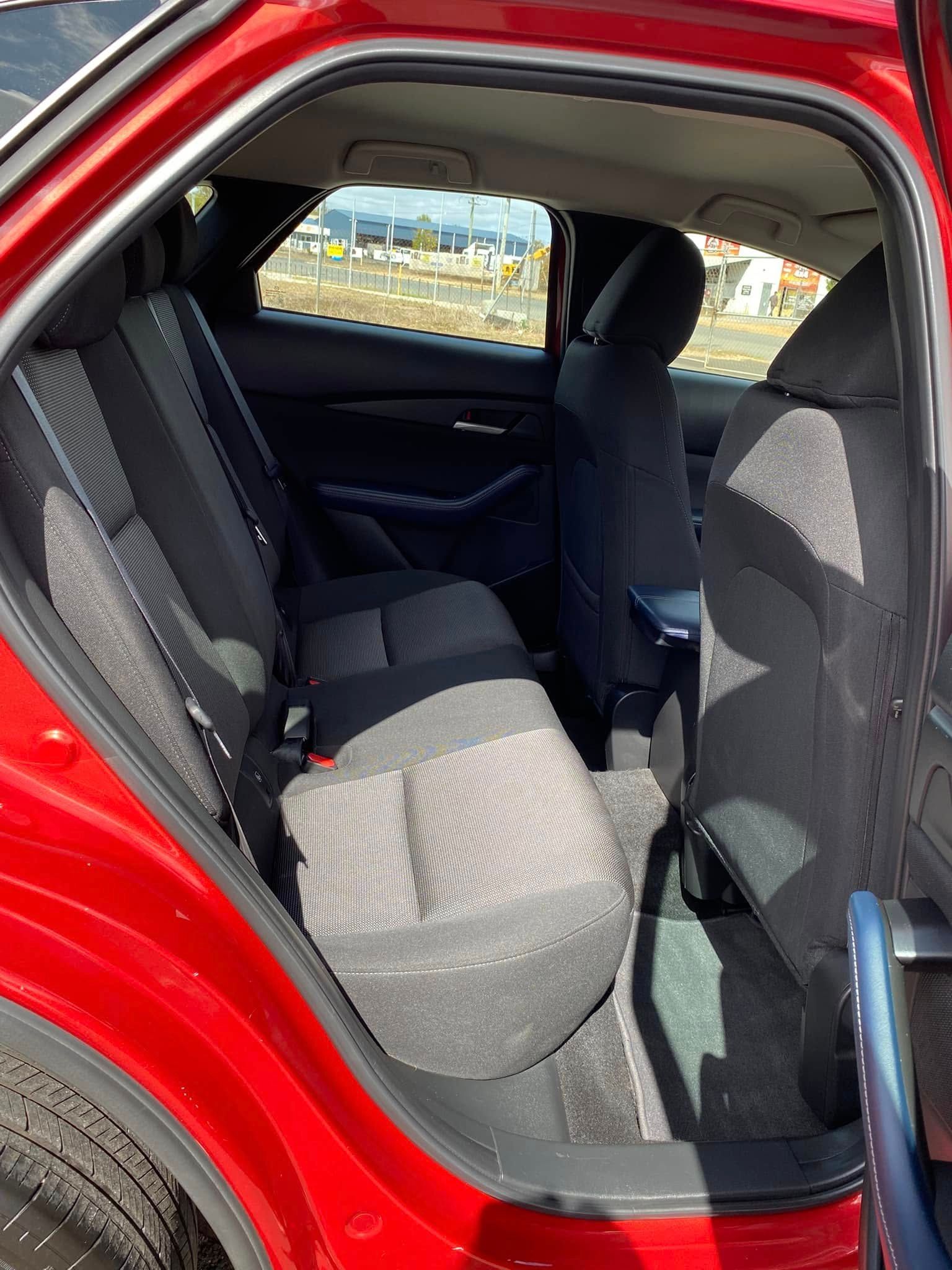 Open Rear Door of A Red Car, Showing the Back Seat and Interior Upholstery — Beclean Auto Detailing in Mareeba, QLD
