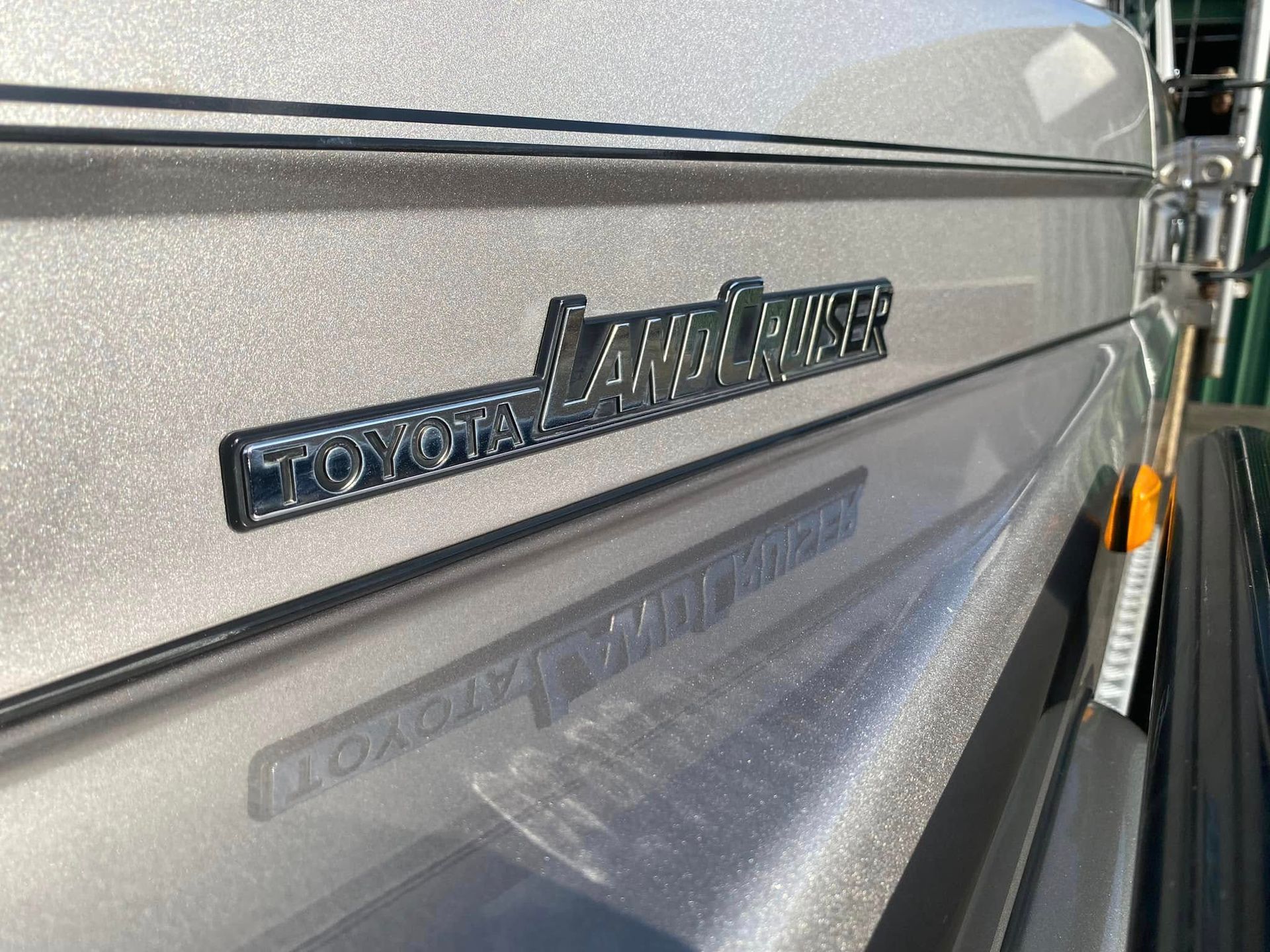 Close-Up of A Silver Rv Side Panel with A Reflective Decal and Black Trim Line — Beclean Auto Detailing in Mareeba, QLD