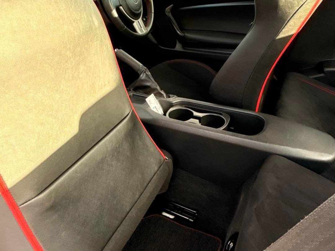 Car interior with black and beige seats and a center console with cup holders — Beclean Auto Detailing in Mareeba, QLD