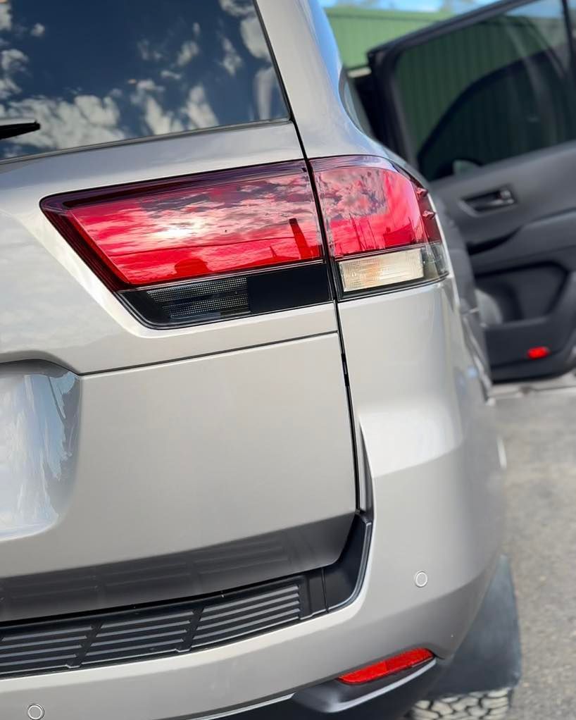 Rear View of A Silver SUV with Red Taillight, Parked Beside Another Vehicle — Beclean Auto Detailing in Mareeba, QLD