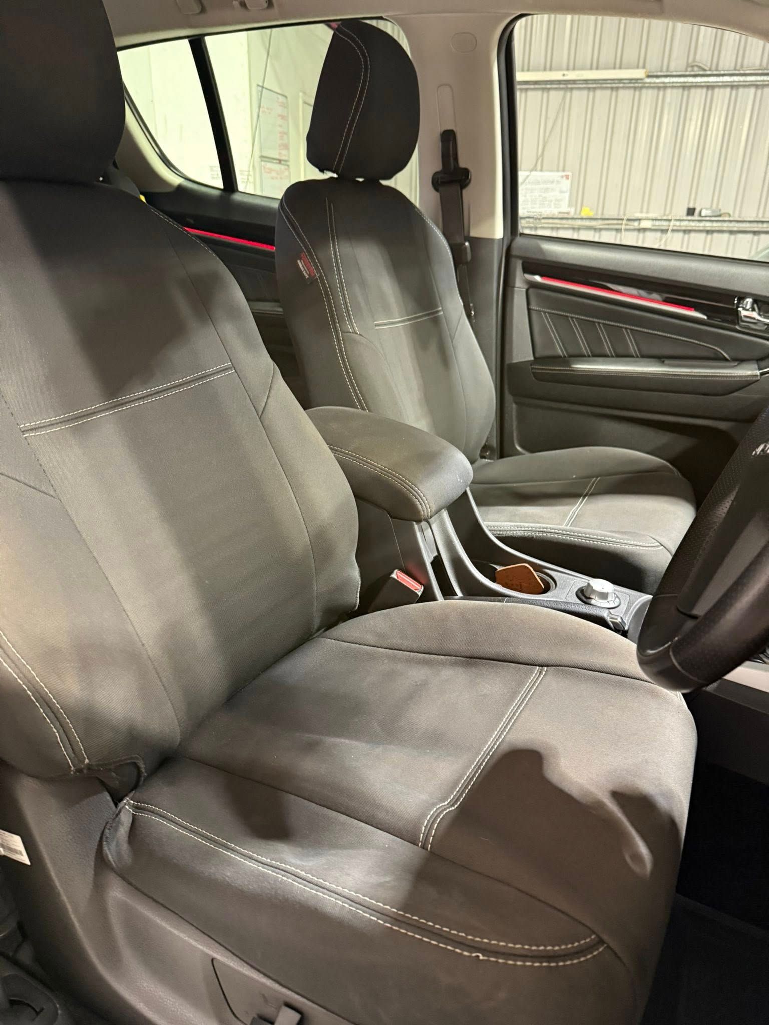 Car Interior with Black Cloth Front Seats and Center Console — Beclean Auto Detailing in Mareeba, QLD