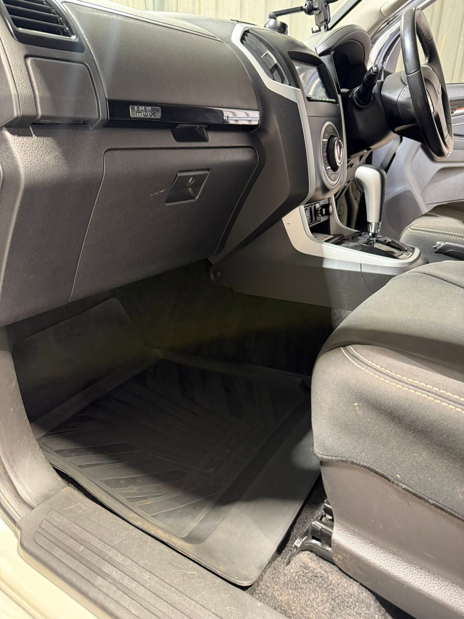 Open car interior showing the passenger footwell, dashboard, steering wheel, and center console — Beclean Auto Detailing in Mareeba, QLD