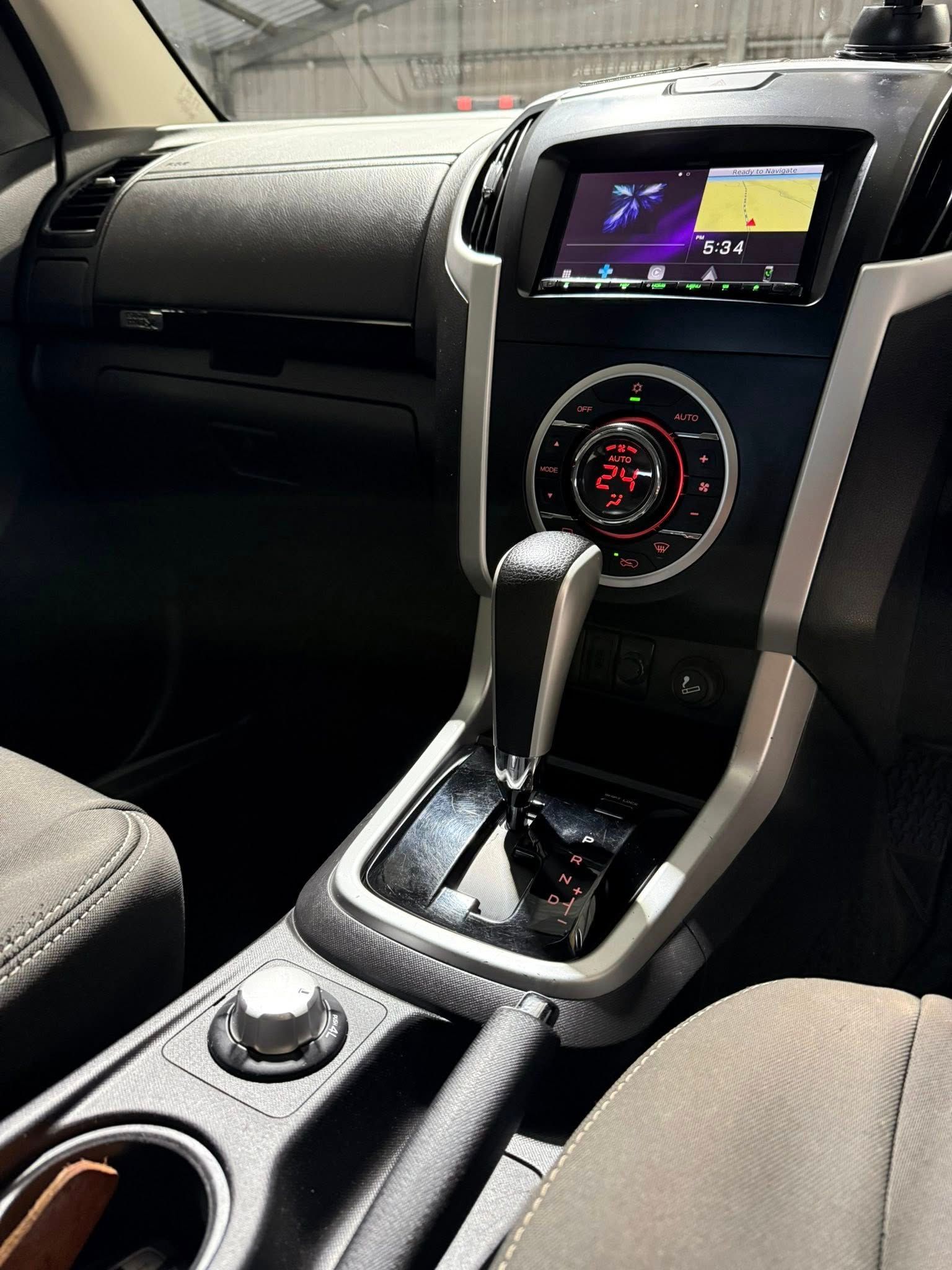 Car interior with center console, gear shift, touchscreen display, and dashboard controls — Beclean Auto Detailing in Mareeba, QLD