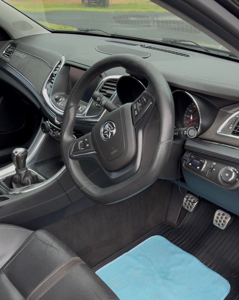Toyota car interior with steering wheel, dashboard, pedals, and blue floor mat — Beclean Auto Detailing in Mareeba, QLD