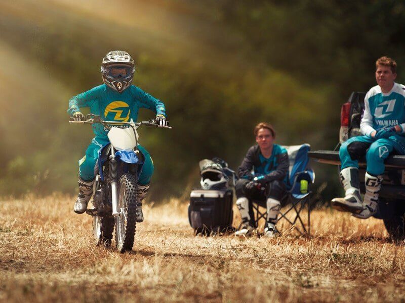 Men Watching Rider On A Motorcycle — Motorcycle Dealer in Berrimah, NT