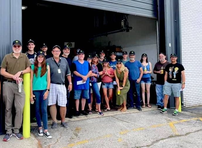 JohnsonRauhoff employees are standing in front of a garage door.