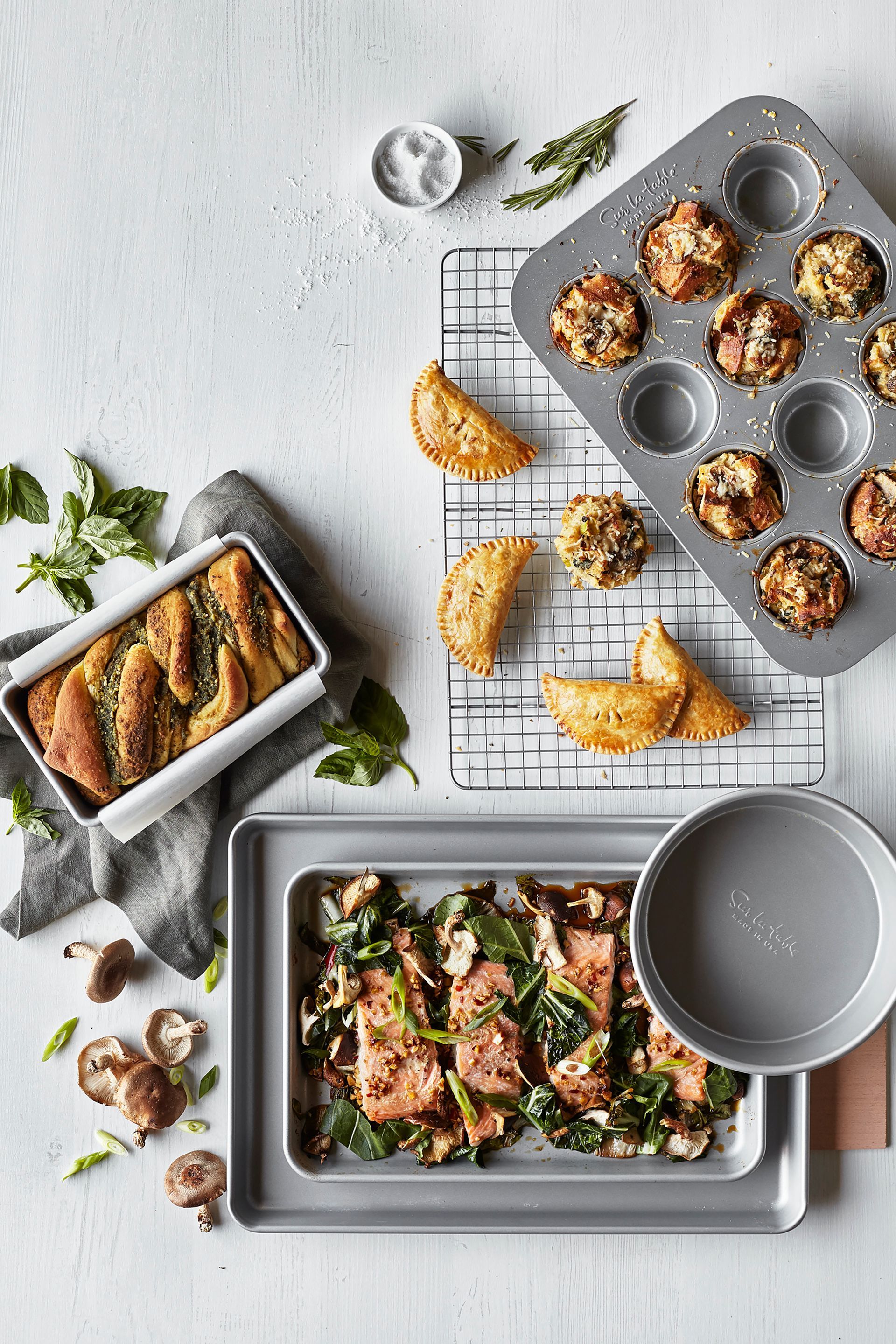 A tray of food is sitting on top of a table next to a pan of food.