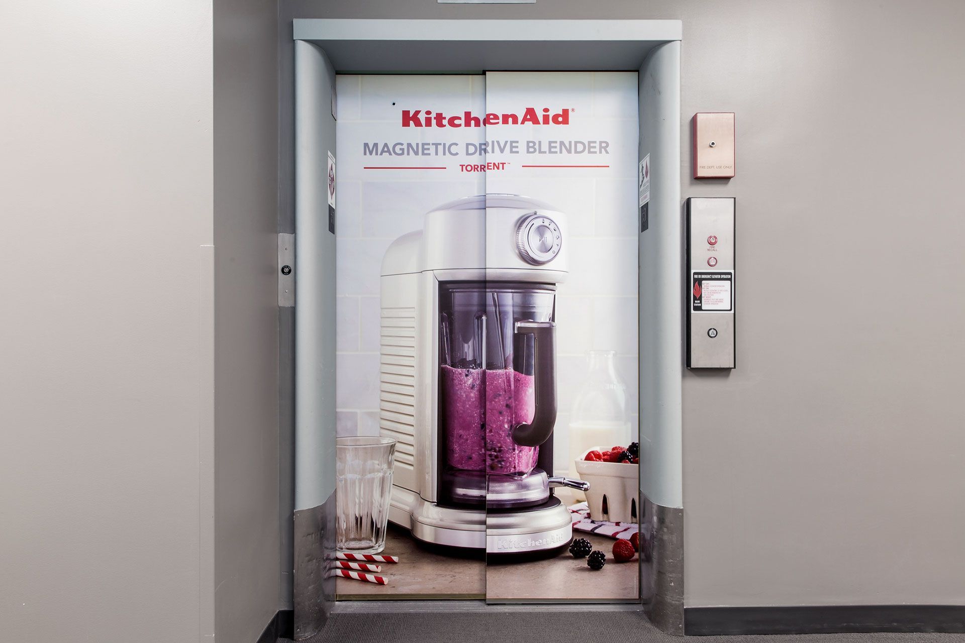 An elevator with a picture of a KitchenAid blender on it.