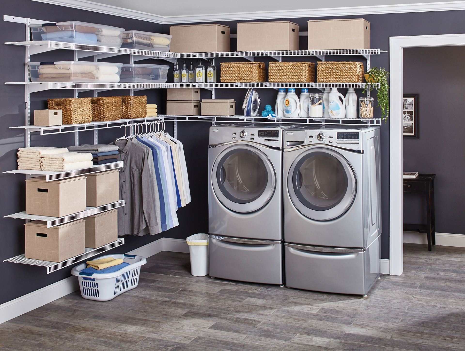 A laundry room with a washer and dryer and a rubbermaid fast track closet solution