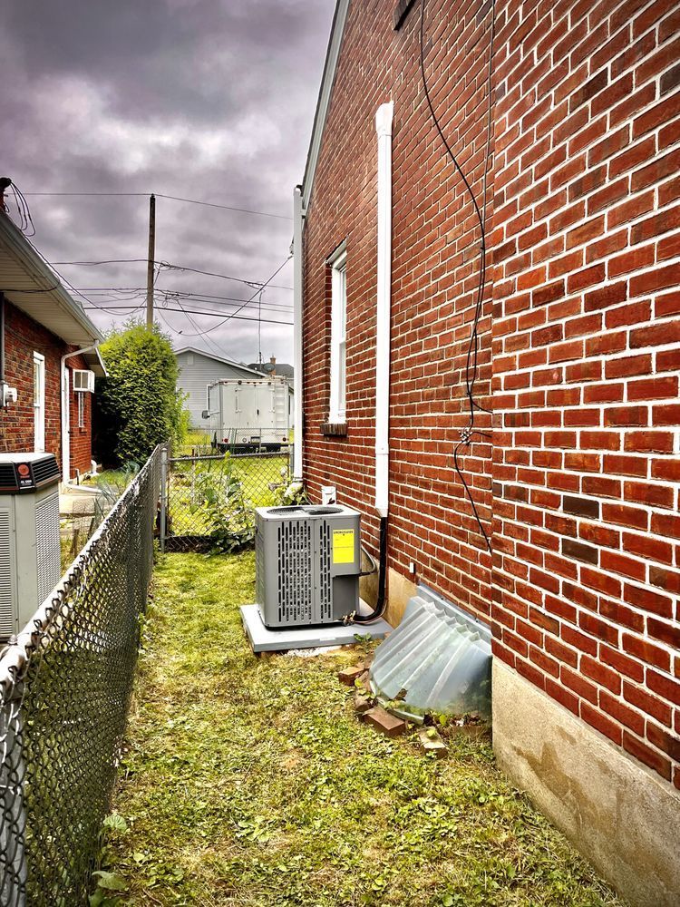 A brick building with an air conditioner on the side of it.