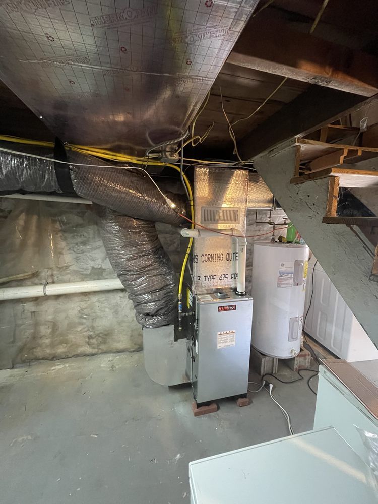 A room with a heater and a water heater in it.