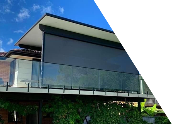 A white awning is hanging from the side of a house