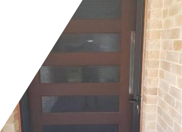A brown door with a brick wall behind it