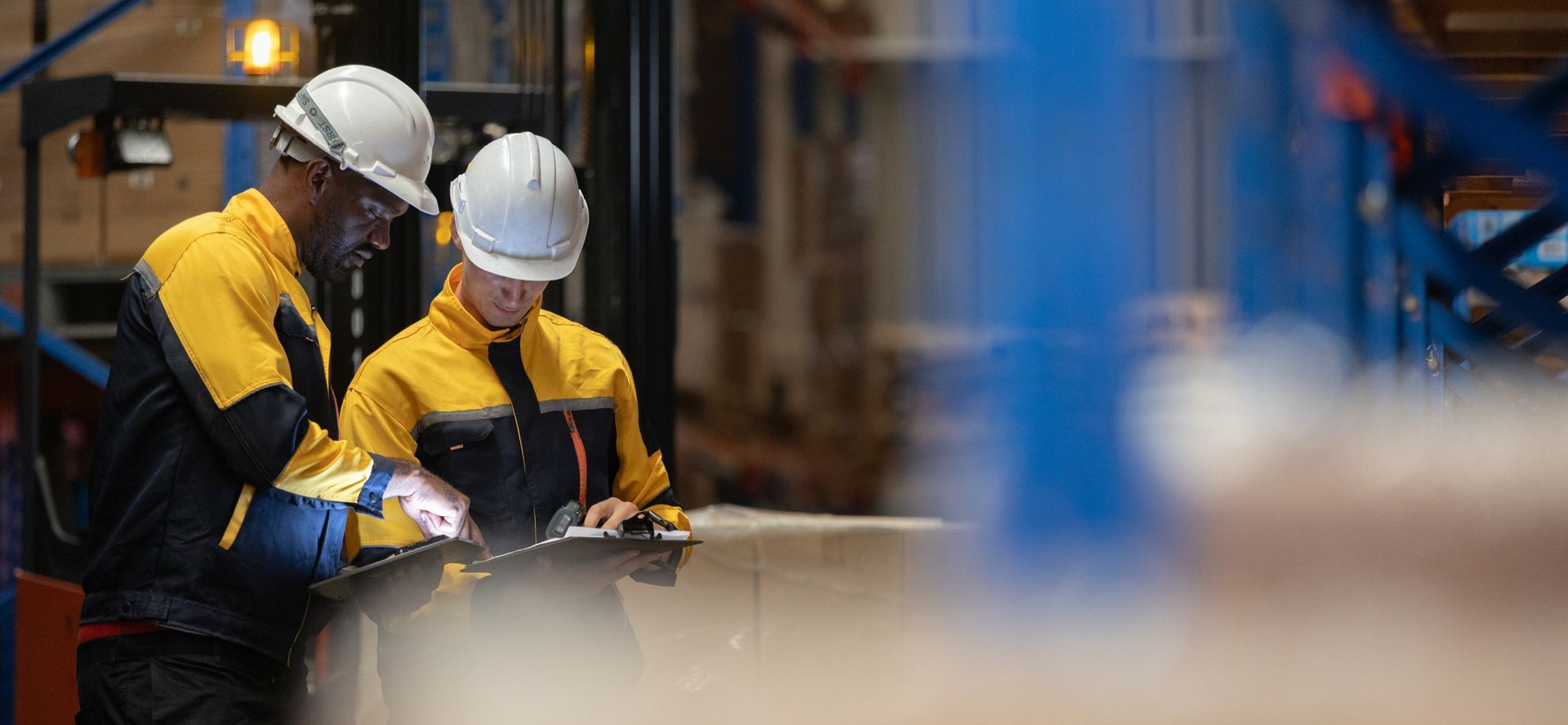 Two Workers Reviewing Warehouse Documents