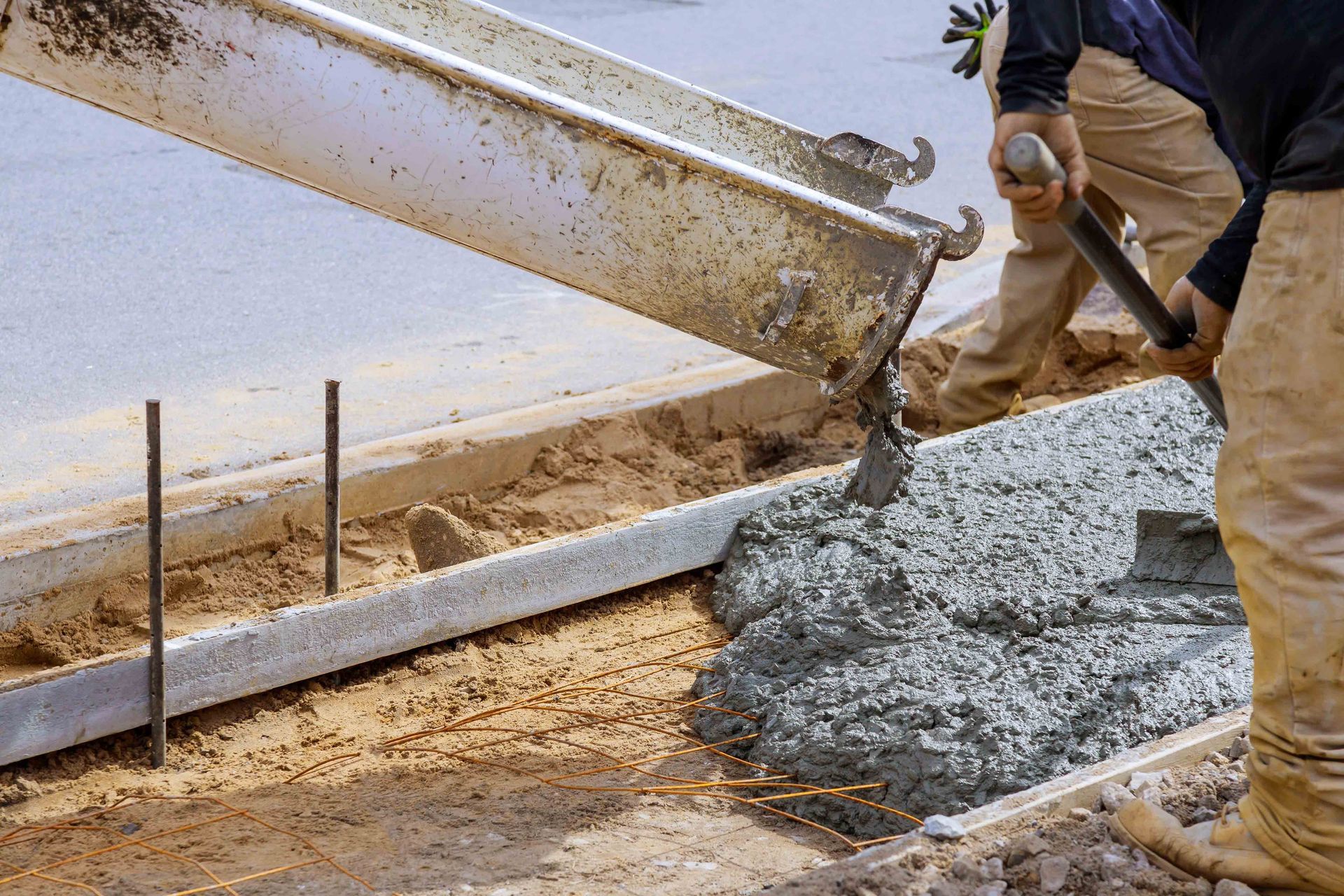 A concrete mix is being poured at a construction site.