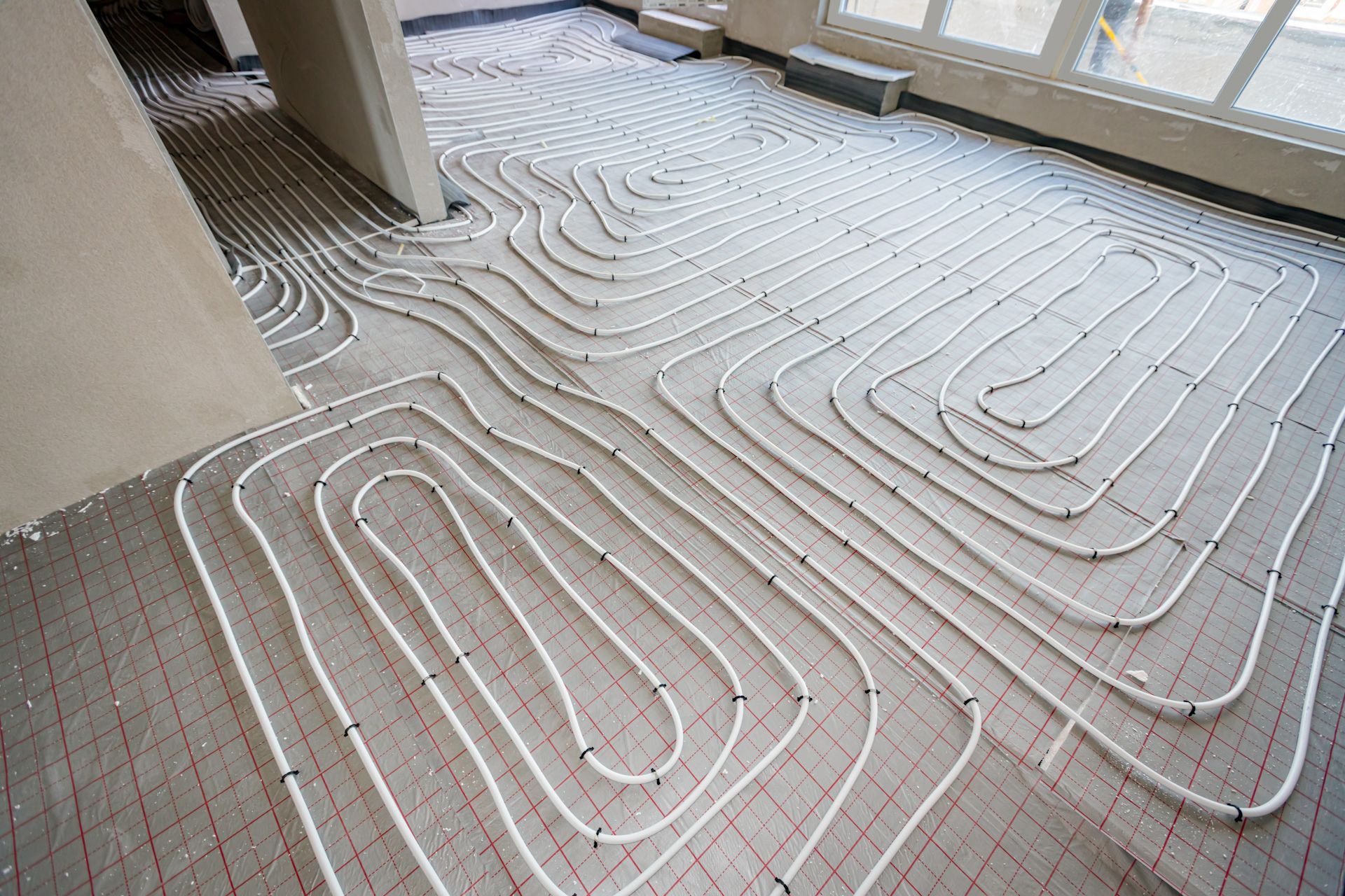 A room with a maze of pipes on the floor.