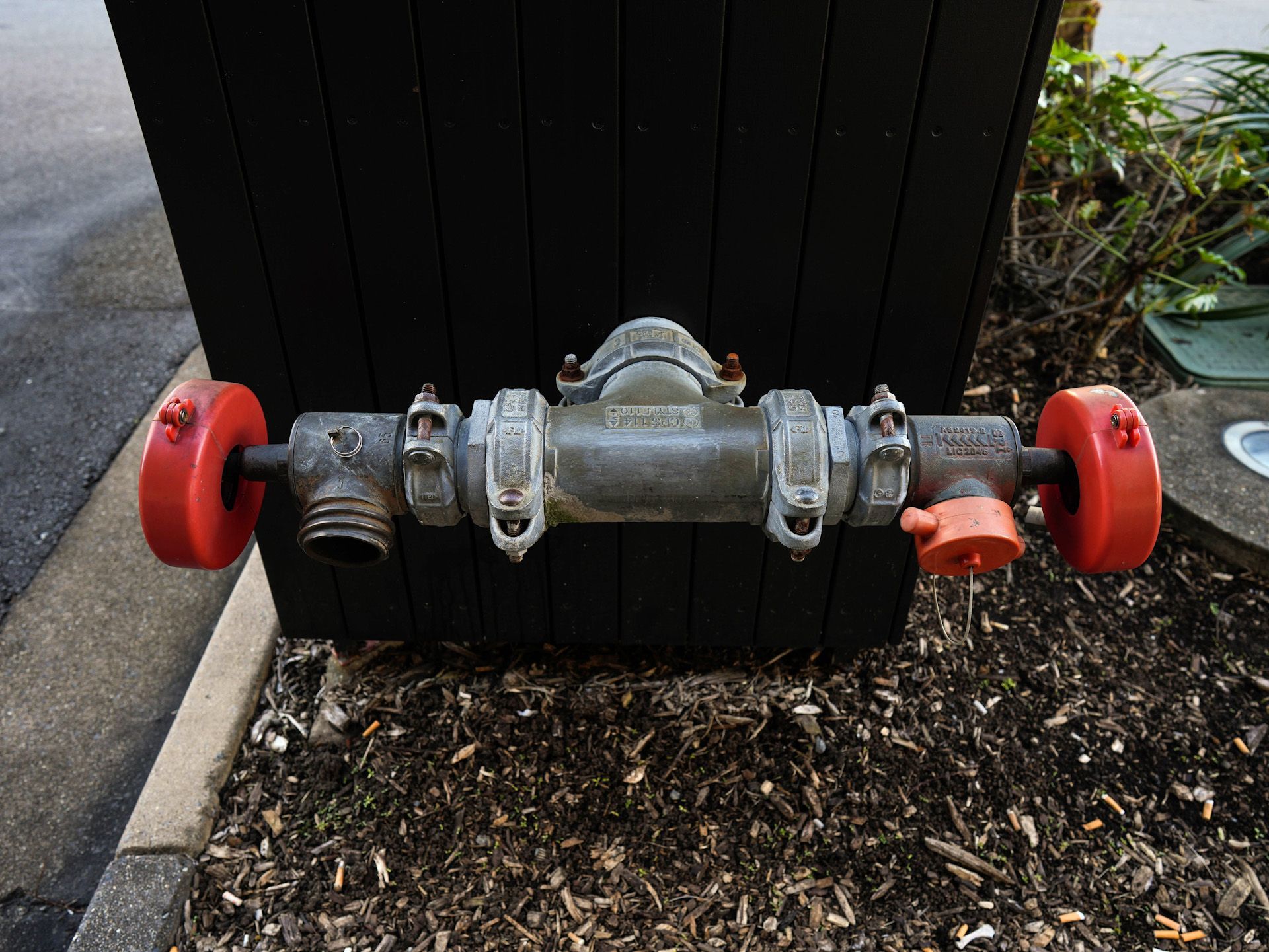 A close up of a fire hydrant with red handles