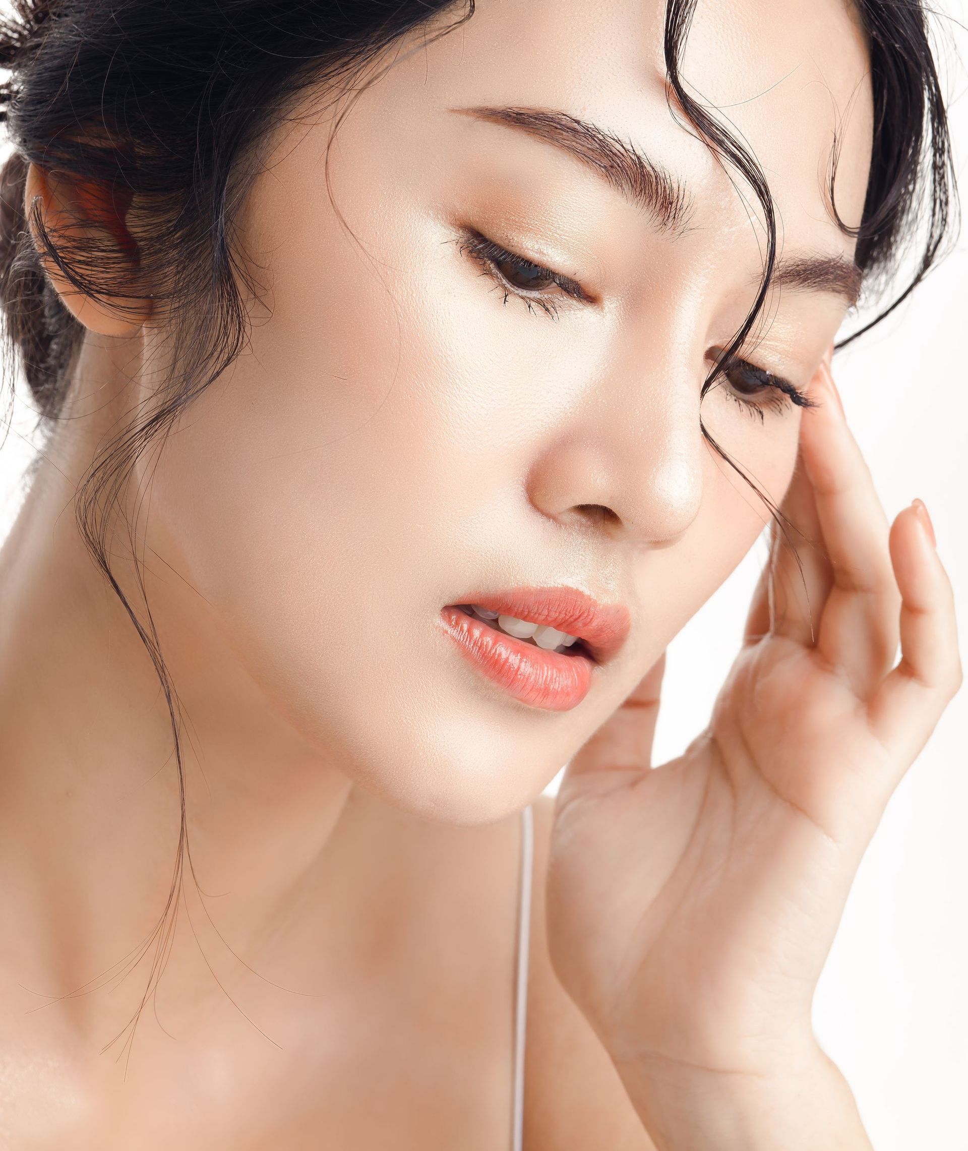 A close up of a woman 's face with her eyes closed