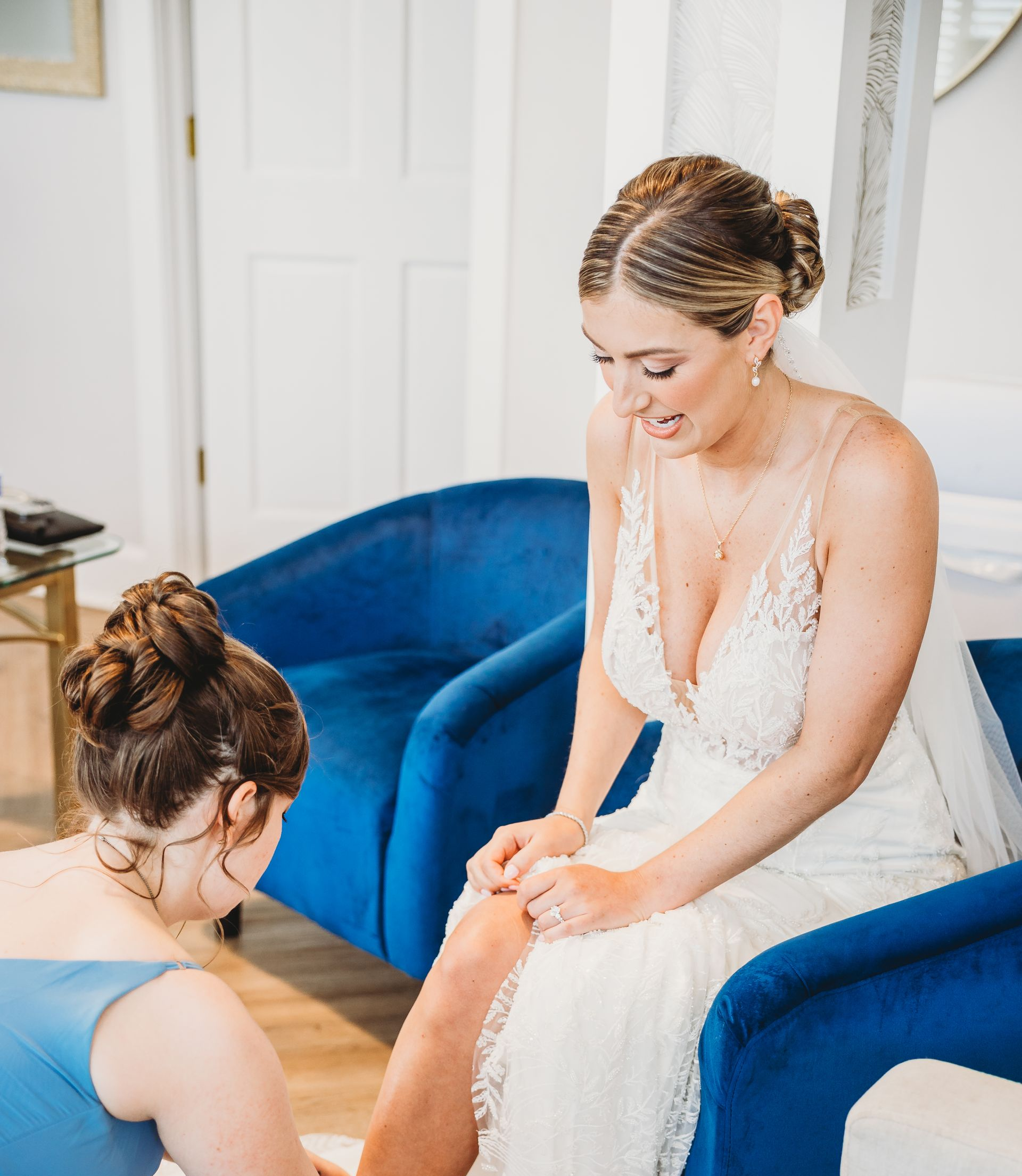 A bridal suite with a blue couch and white chairs