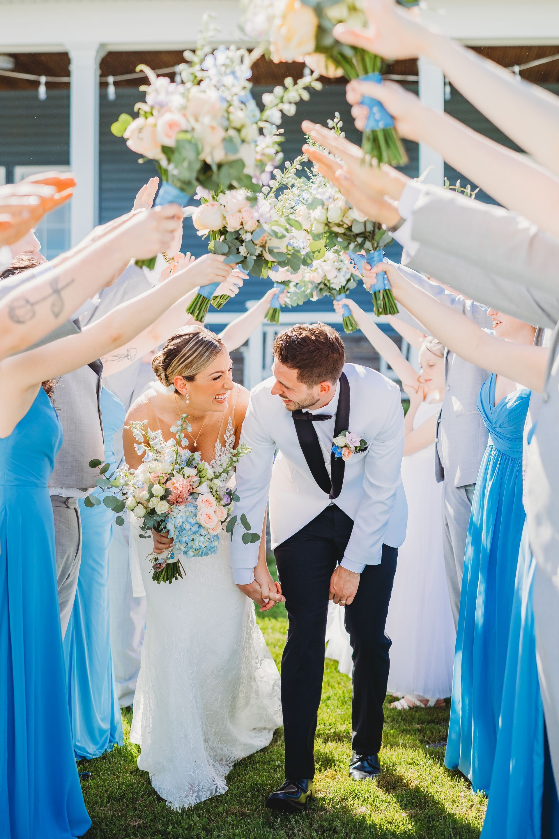 A bride and groom are posing for a picture in front of a lake.