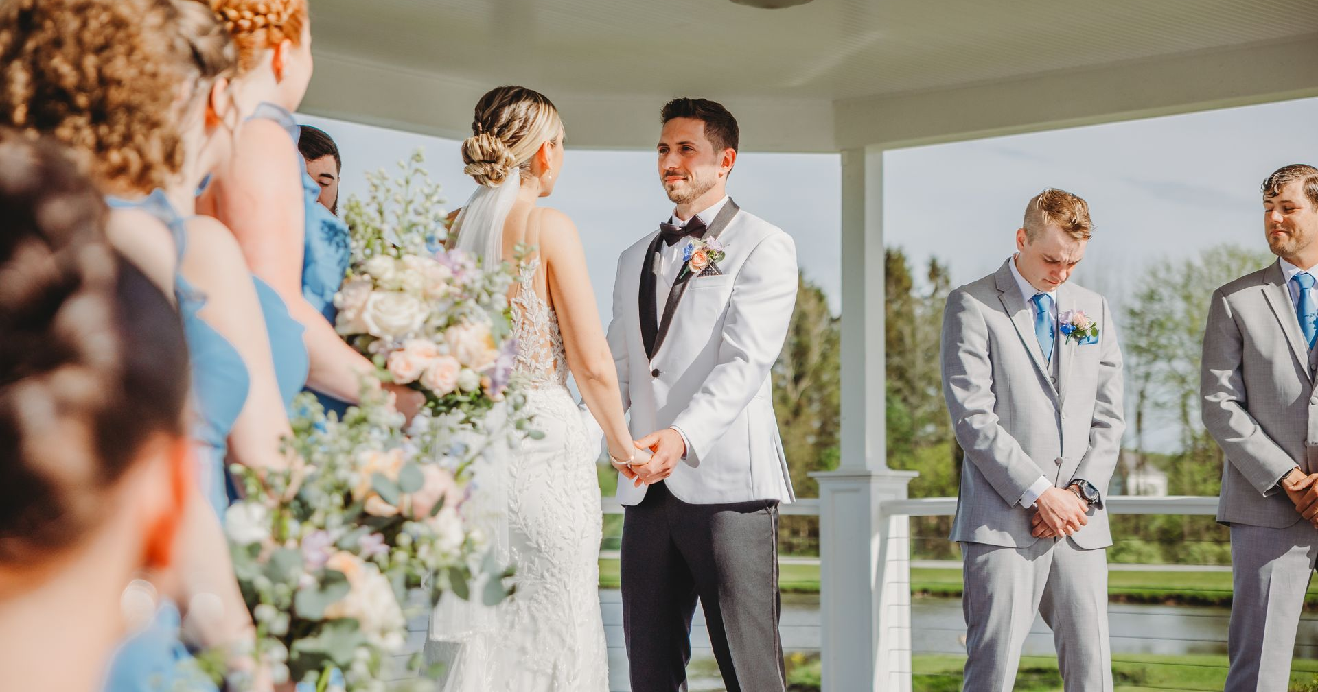 The bride and groom are posing for a picture with their wedding party.