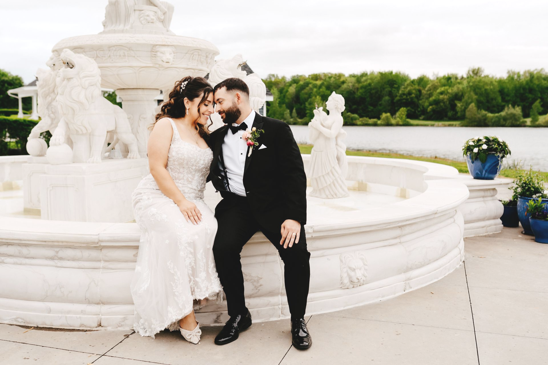 A bride and groom are posing for a picture under a gazebo.