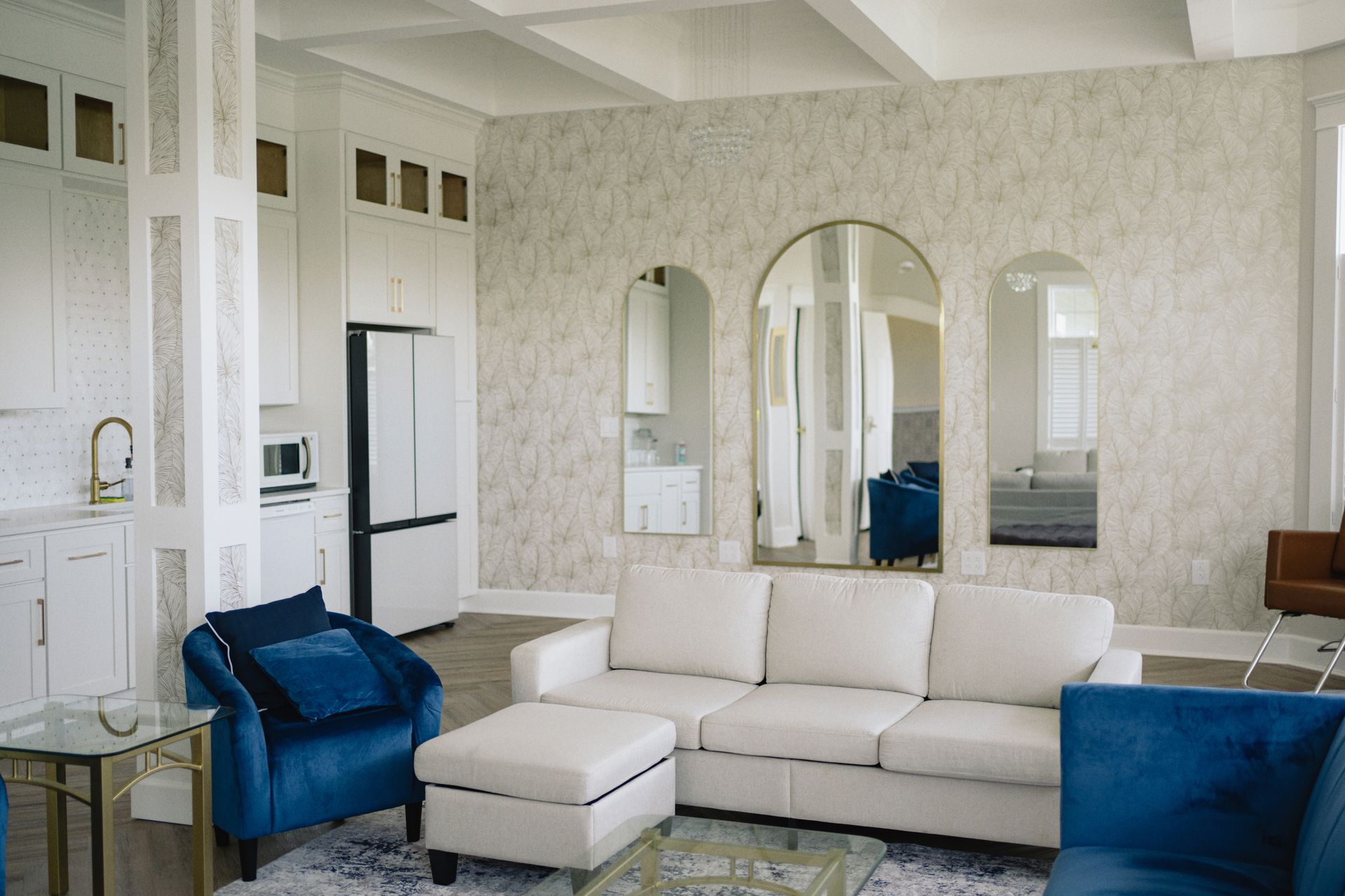 A bridal suite with a white couch and blue chairs.