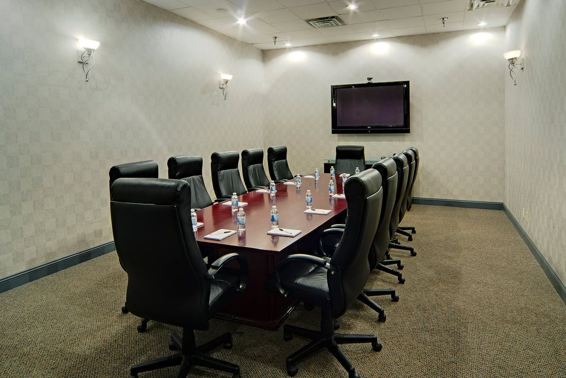 A conference room with a long table and chairs