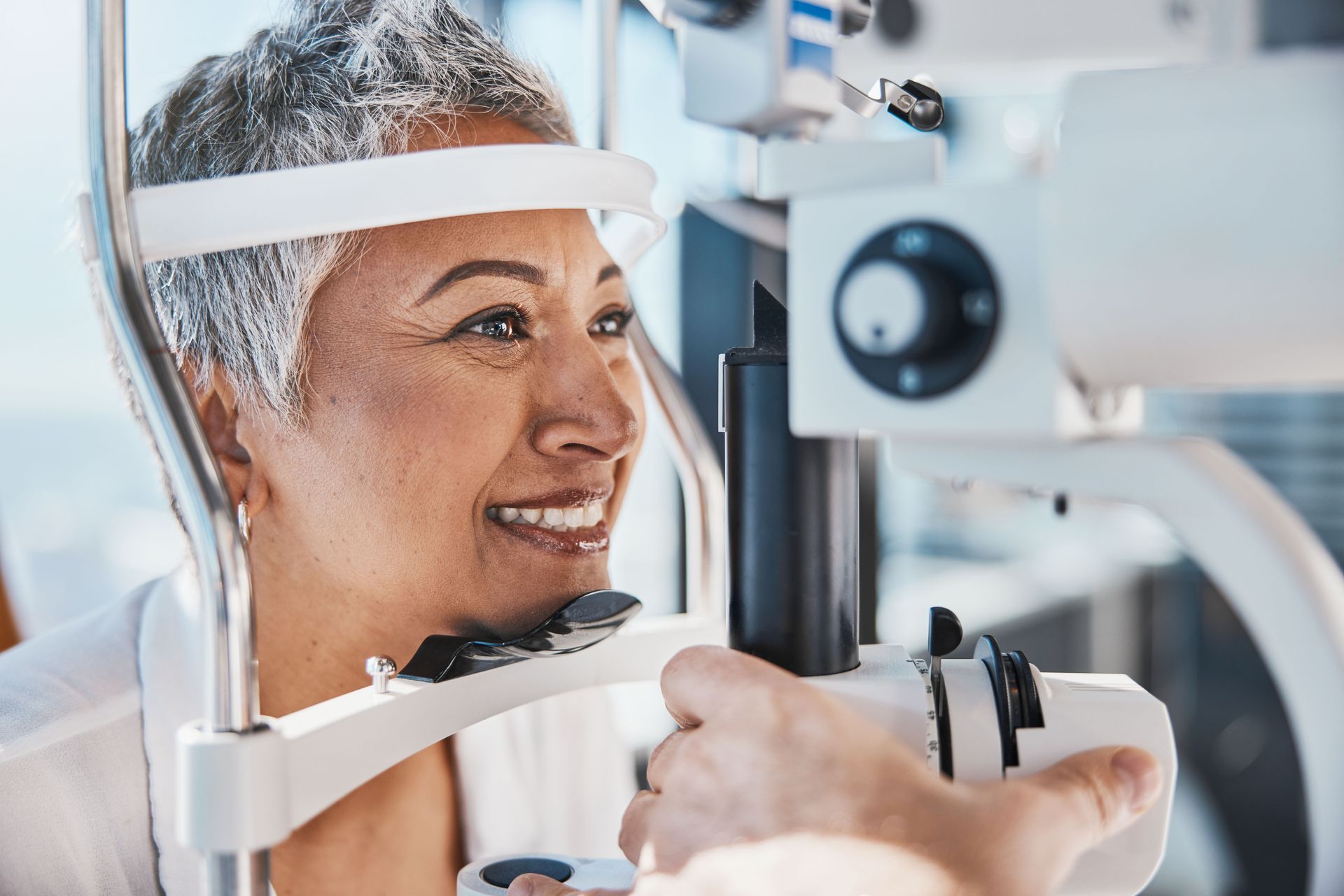 Patient smiling during an eye exam at a vision clinic