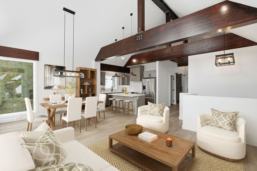 Bright open-plan living room with white furniture, wood beams, and large windows