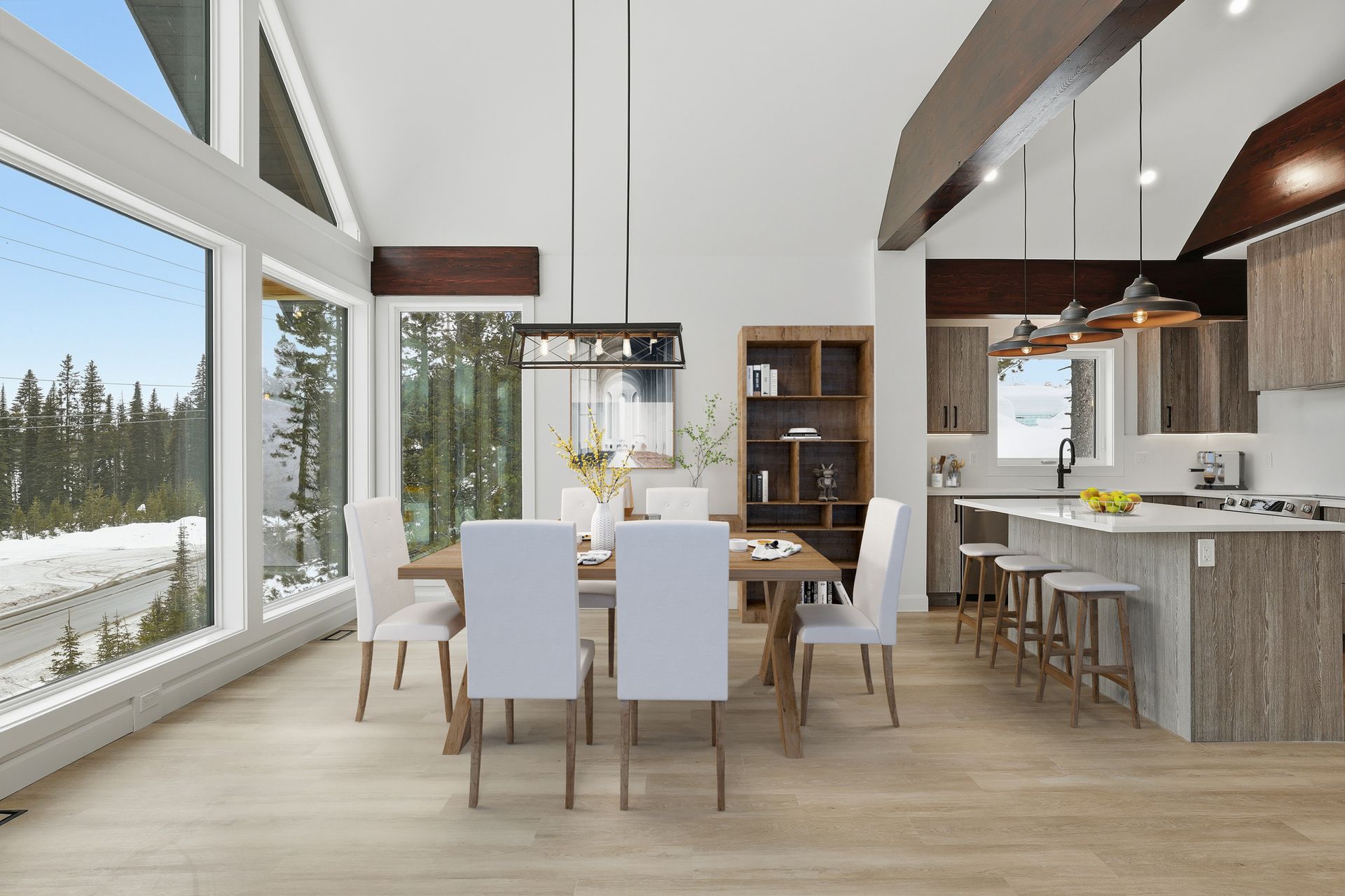 Bright modern dining room with large windows, snowy forest view, and open kitchen with island stools