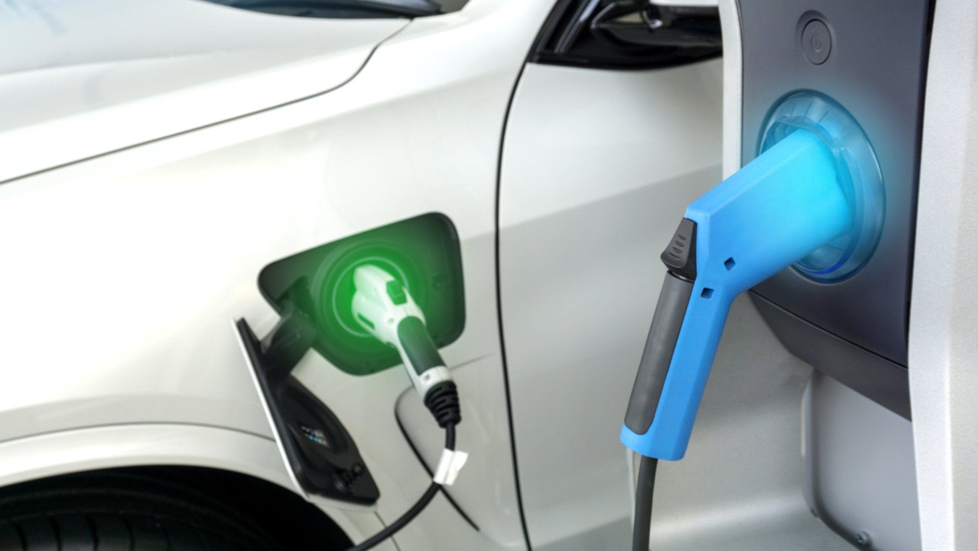 An electric car is being charged at a charging station.