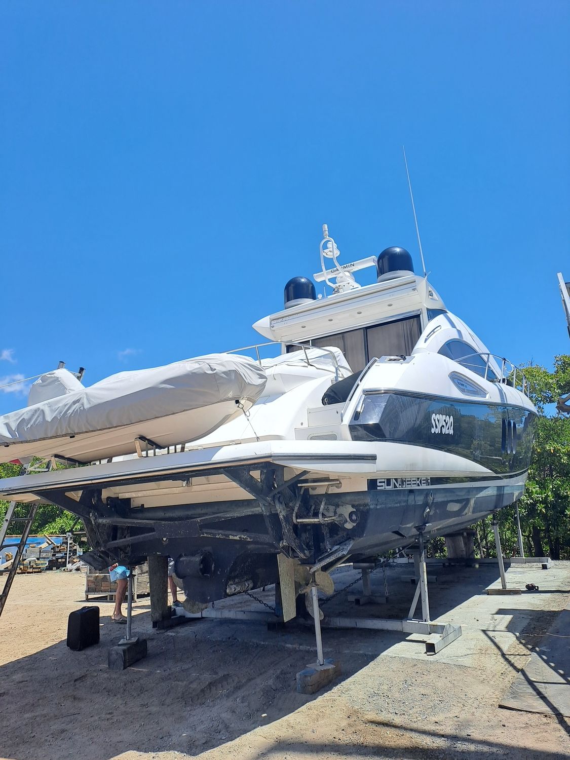 A Boat Is Being Lifted By A Crane In A Marina — Edge's Boatyard In Whitsundays, QLD