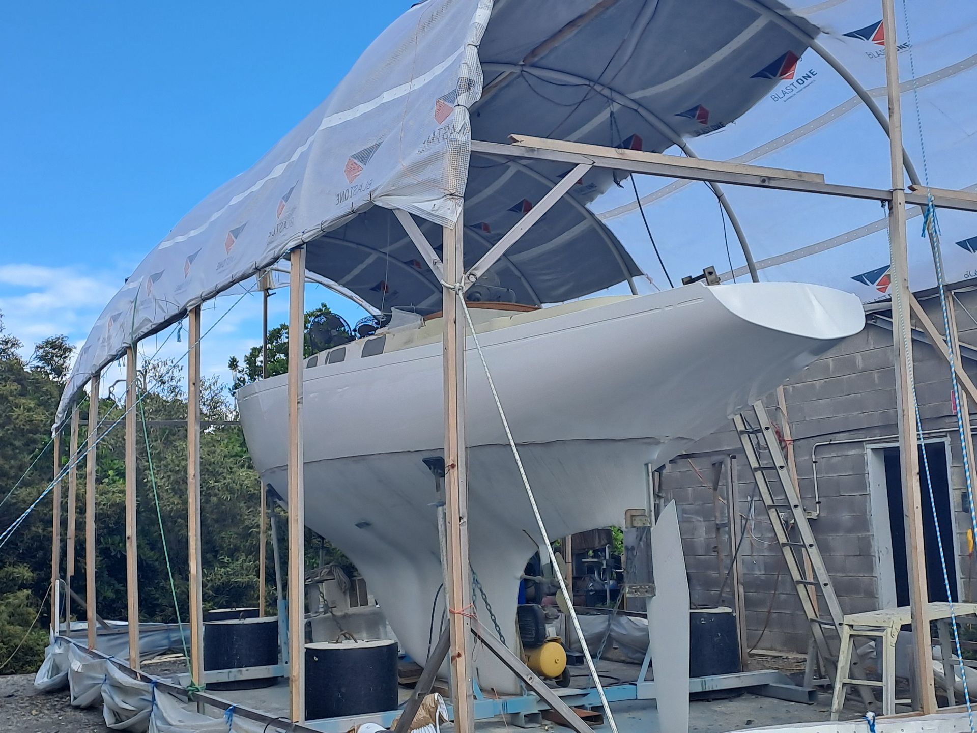A Boat Lifted Over Water With A Metal Frame — Edge's Boatyard In Jubilee Pocket, QLD