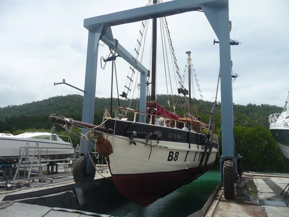 A Boat With The Number B9 Is Being Lifted By A Crane — Edge's Boatyard In Jubilee Pocket, QLD