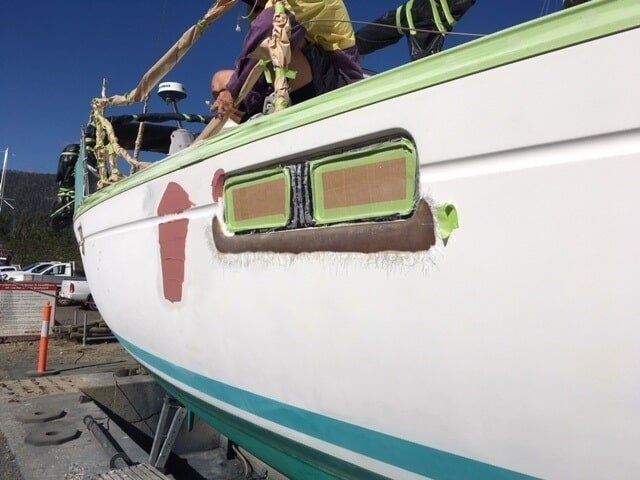 A White Boat With A Green Trim Is Being Painted — Edge's Boatyard In Whitsundays, QLD