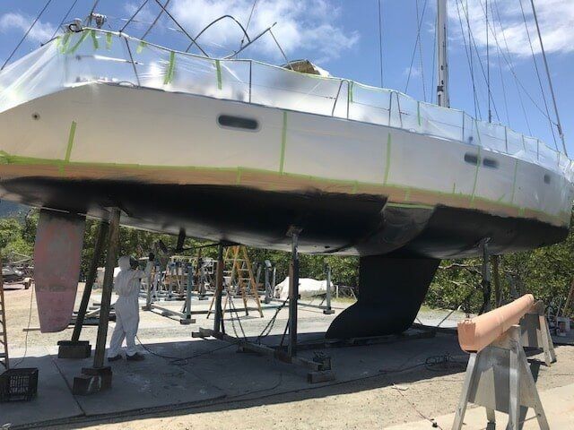 A White Sailboat Is Being Painted In A Yard — Edge's Boatyard In Jubilee Pocket, QLD