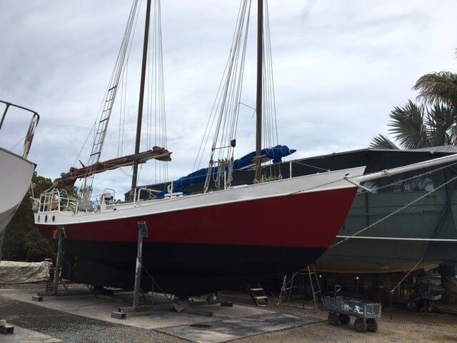 A Red And White Sailboat With The Name Sunshine On It — Edge's Boatyard In Jubilee Pocket, QLD
