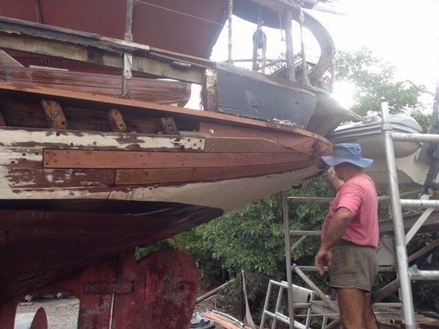 A Man In A Pink Shirt Is Standing Beside Of  The Boat — Edge's Boatyard In Jubilee Pocket, QLD