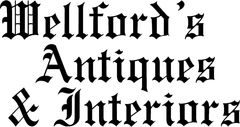 Blackletter logo reading “Wellford’s Antiques & Interiors” in black on white background