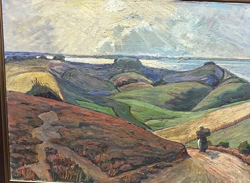 Painted landscape of rolling green hills, a winding path, and a small figure under a cloudy sky