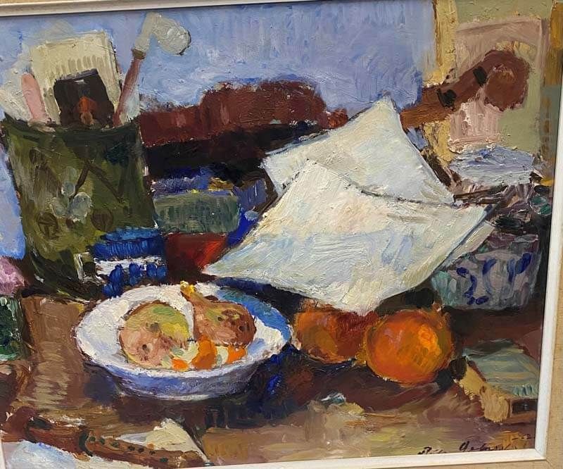 Still life painting with a white cloth, fruit bowl, orange, and jars on a table