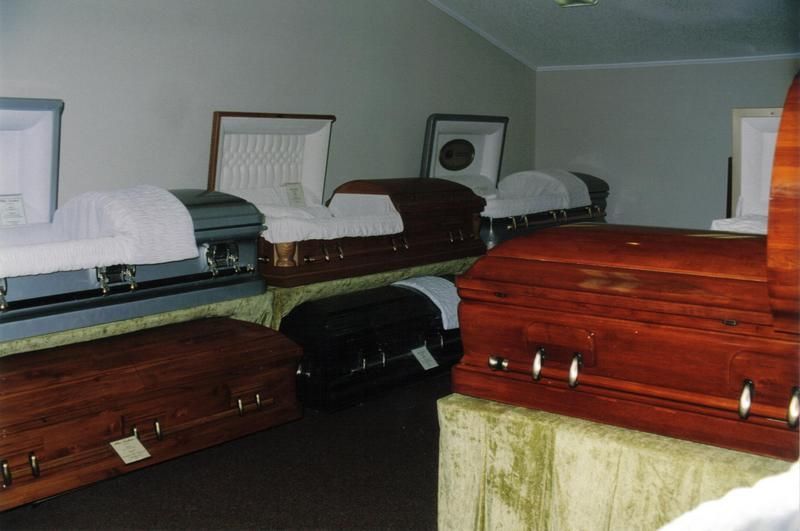 a row of coffins are lined up in a room