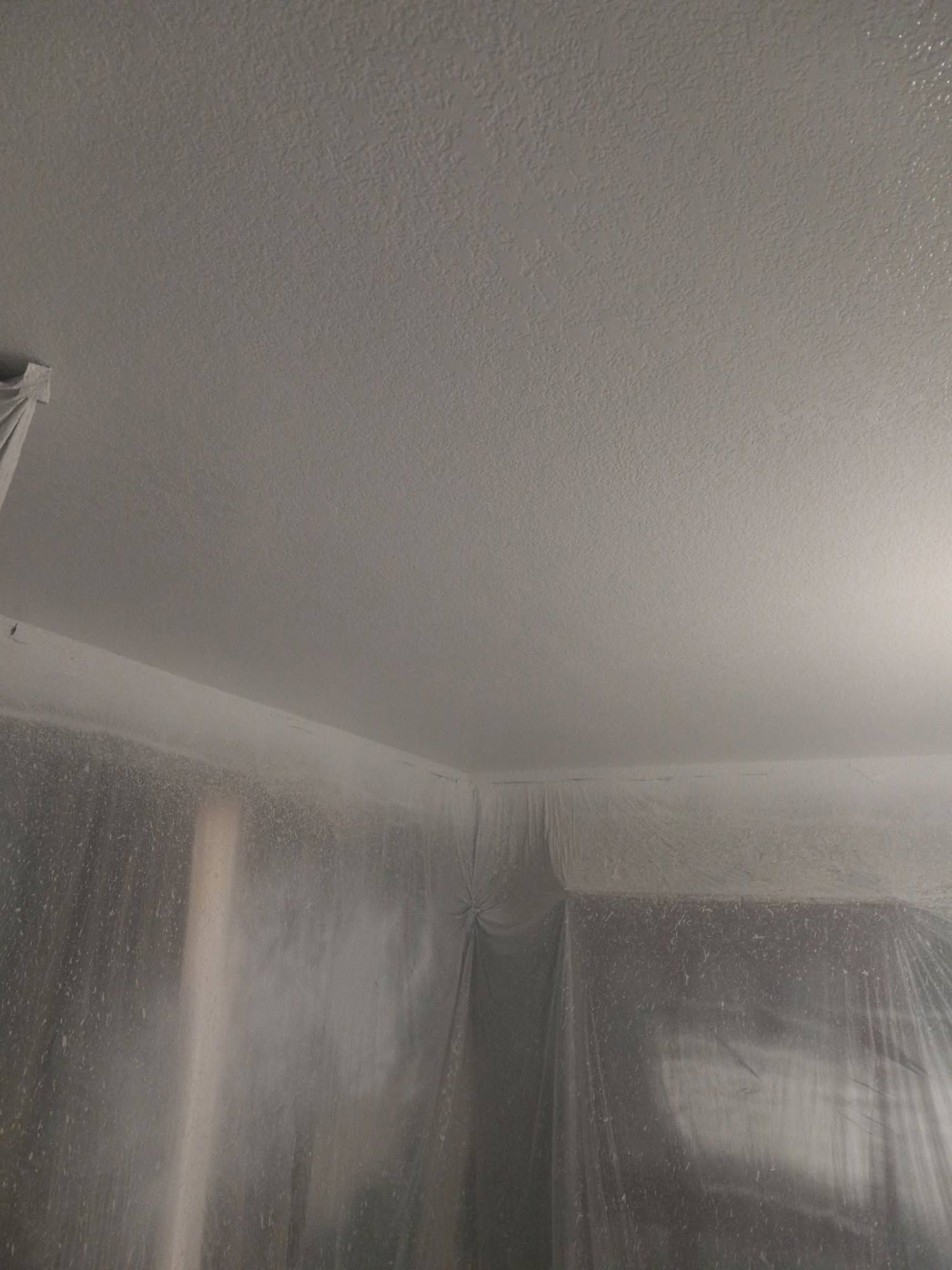 Gray ceiling and walls with heavy water damage or condensation in a room