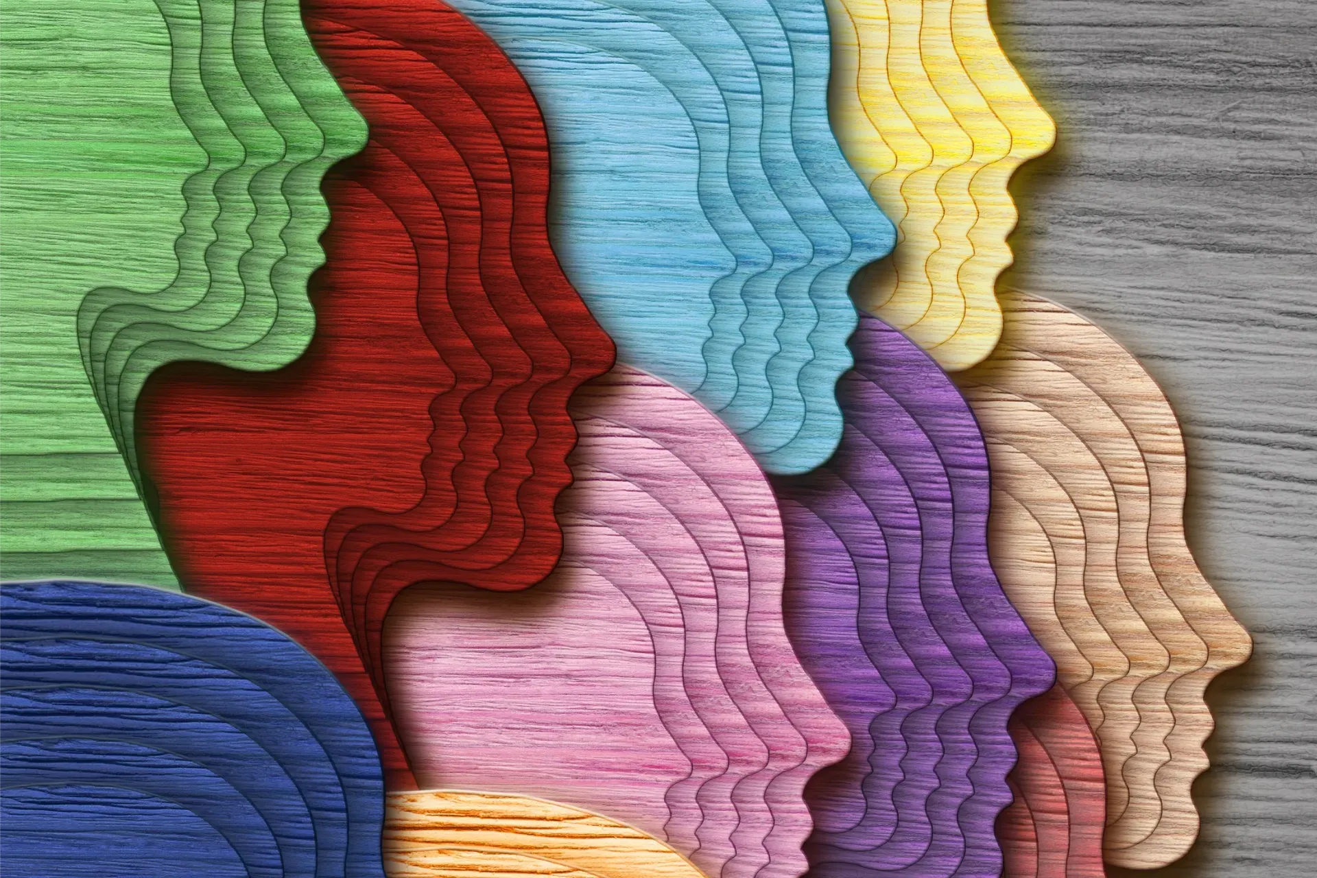 Colourful heads on a wood background showing the concept of identity