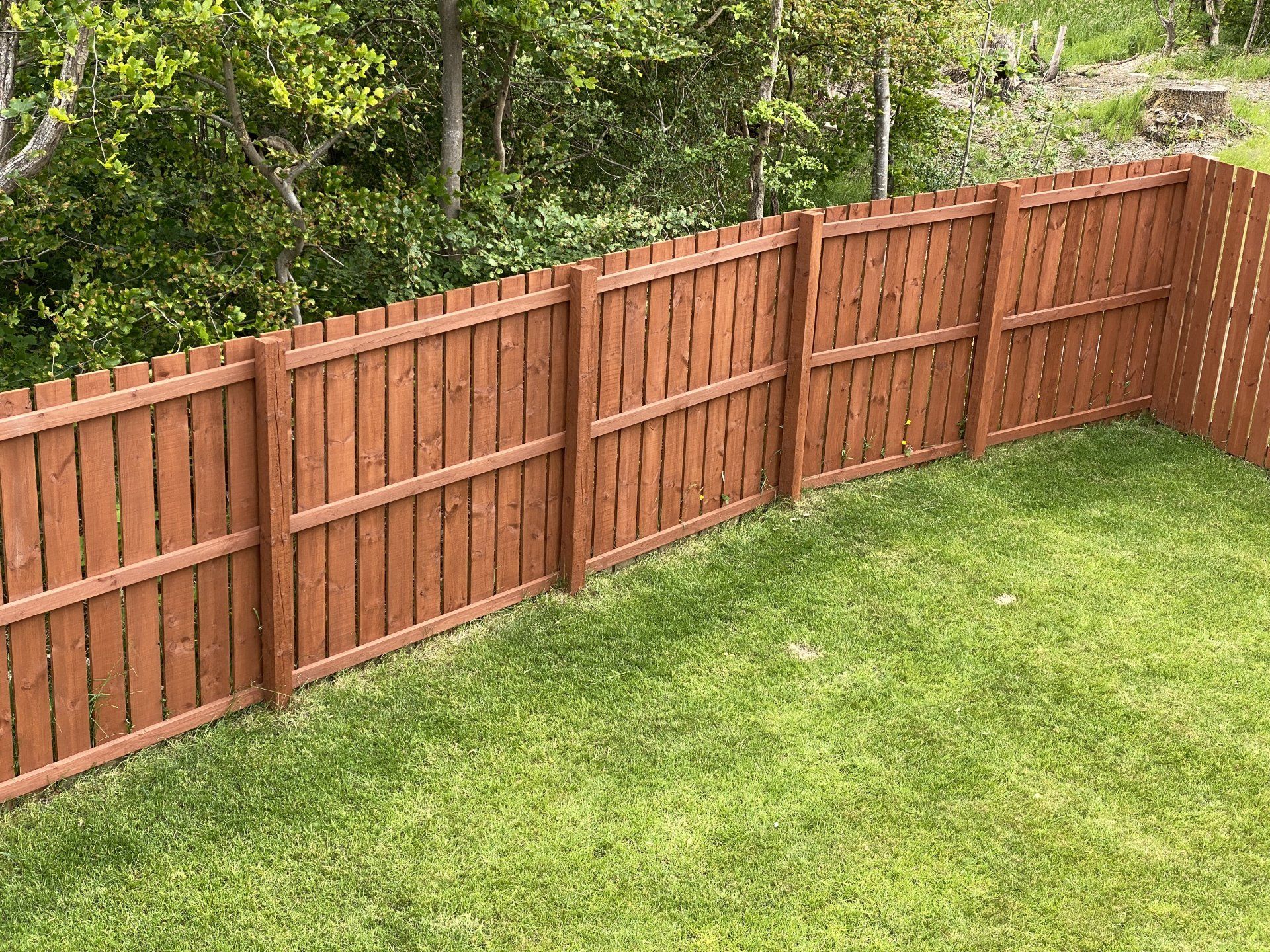 A backyard fence that was installed by A Modern Touch